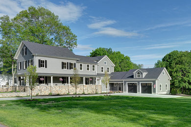 Aménagement d'une grande façade de maison grise classique en bois à un étage avec un toit à deux pans et un toit en shingle.