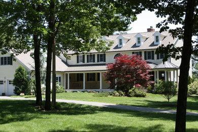 Example of a country two-story exterior home design in Boston