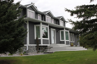 Example of a classic gray two-story mixed siding exterior home design in Edmonton with a hip roof
