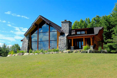 Example of a large mountain style one-story wood exterior home design in Other with a shingle roof