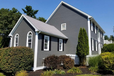 Example of a mid-sized classic gray two-story wood exterior home design with a shingle roof