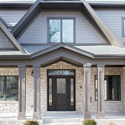 Large traditional gray two-story concrete fiberboard exterior home idea in Chicago with a shingle roof