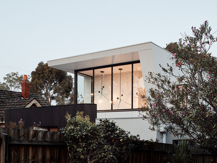 Large contemporary white two-story wood exterior home idea with a metal roof