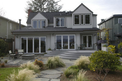 Example of a large classic gray two-story vinyl exterior home design in San Francisco with a shingle roof