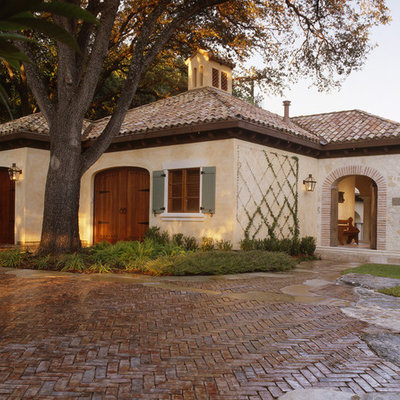 Inspiration for a mid-sized mediterranean beige two-story stone exterior home remodel in Austin with a shingle roof