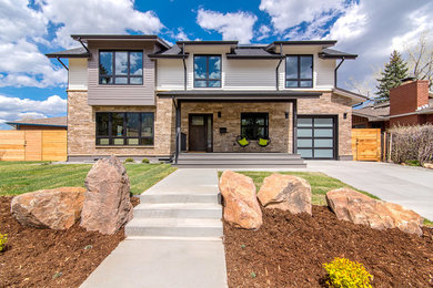 Inspiration for a large transitional white two-story stone house exterior remodel in Denver with a shed roof and a shingle roof