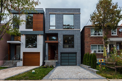 Inspiration for a small modern split-level stucco flat roof remodel in Toronto