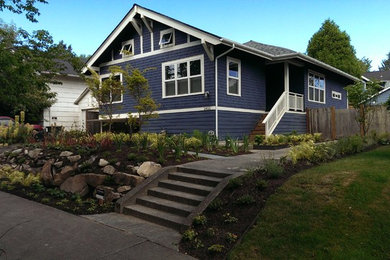 Medium sized and blue contemporary two floor house exterior in Seattle with wood cladding.