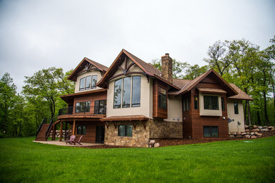 Example of a transitional three-story mixed siding exterior home design in Minneapolis with a shingle roof