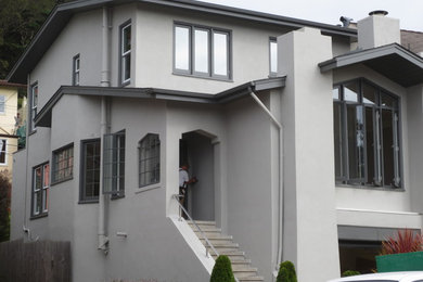 Inspiration for a large transitional gray three-story stucco exterior home remodel in San Francisco