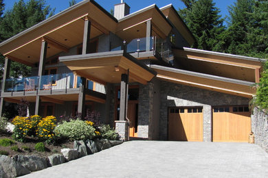 Large mountain style two-story house exterior photo in Other with a metal roof
