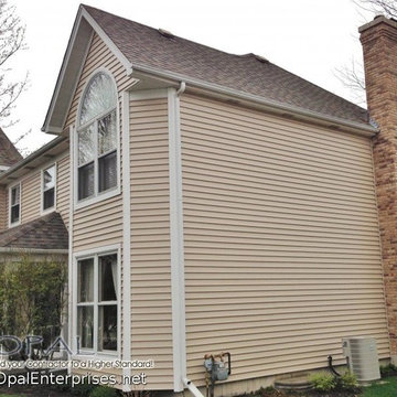 Alside Vinyl Siding in Vintage Wicker with white trim and white windows.