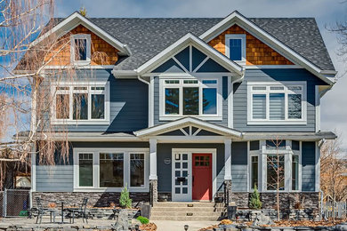 Large transitional blue two-story concrete fiberboard exterior home photo in Calgary with a shingle roof