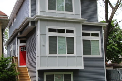 Inspiration for a mid-sized transitional gray three-story mixed siding exterior home remodel in Chicago with a metal roof