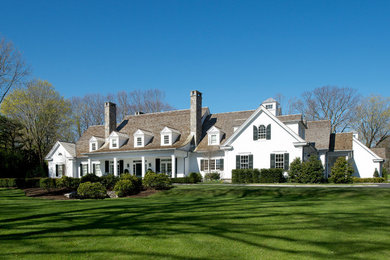 Example of a huge classic two-story gable roof design in New York