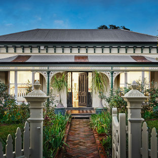 Design ideas for a victorian one-storey white house exterior in Melbourne with a hip roof and a metal roof.