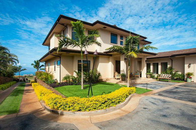 Example of a large transitional beige two-story stucco exterior home design in Hawaii