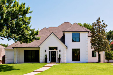 Example of a small minimalist white two-story brick house exterior design in Dallas with a hip roof and a tile roof