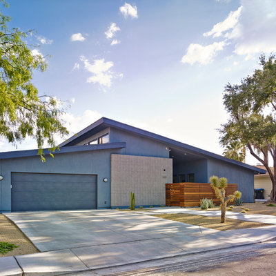 Mid-sized 1960s blue one-story stucco exterior home photo in Las Vegas with a shed roof