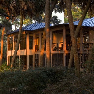 Mid-sized trendy gray two-story wood exterior home photo in Charleston with a hip roof