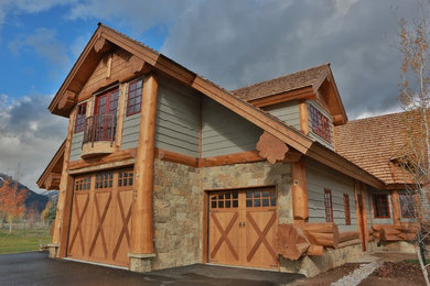 Large mountain style gray two-story vinyl exterior home photo in Other with a clipped gable roof