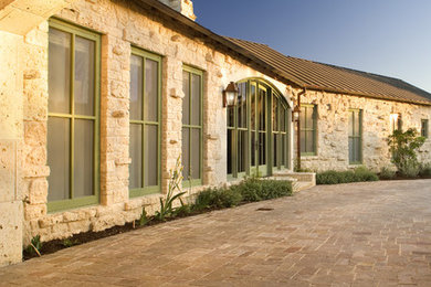Inspiration for a rustic stone exterior home remodel in Austin