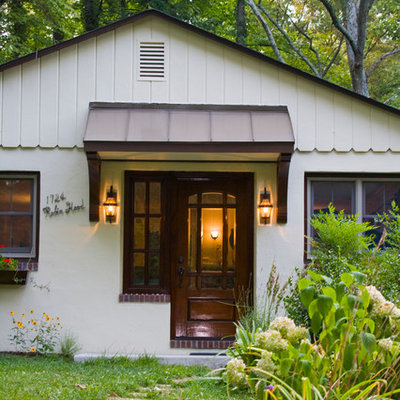 Example of a small classic white one-story stucco gable roof design in Baltimore
