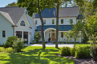 Inspiration for a large coastal white three-story wood house exterior remodel in DC Metro with a shed roof and a mixed material roof