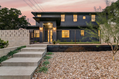 Mid-sized transitional blue two-story exterior home idea in Austin with a metal roof