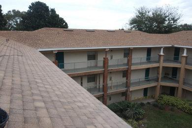 Example of an apartment exterior design in Orlando with a shingle roof