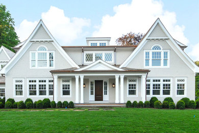 Large traditional beige two-story wood exterior home idea in New York with a shingle roof