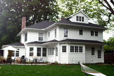 Large elegant white two-story vinyl exterior home photo in New York