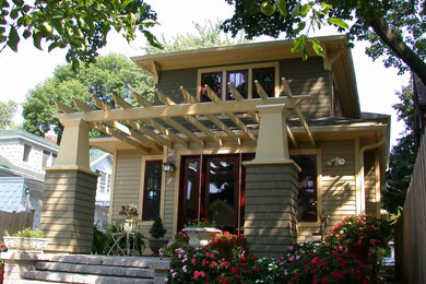 Example of a large classic green two-story mixed siding exterior home design in Milwaukee with a hip roof