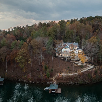 Large elegant blue two-story mixed siding exterior home photo in Other with a shingle roof