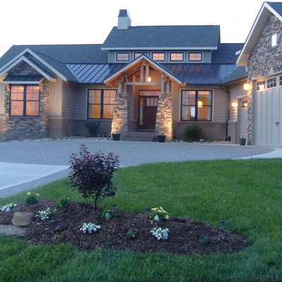 Mid-sized arts and crafts beige one-story mixed siding exterior home photo in St Louis with a metal roof