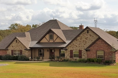 Large traditional brown one-story mixed siding exterior home idea in Oklahoma City with a shingle roof