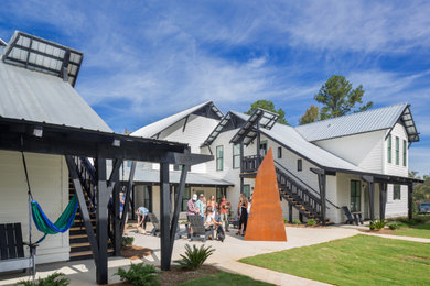 Example of a mid-sized cottage white two-story wood exterior home design in Atlanta with a metal roof