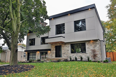 Mid-sized contemporary gray two-story stucco exterior home idea in Toronto with a shed roof