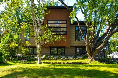 Mid-sized trendy brown two-story wood exterior home photo in Ottawa with a mixed material roof