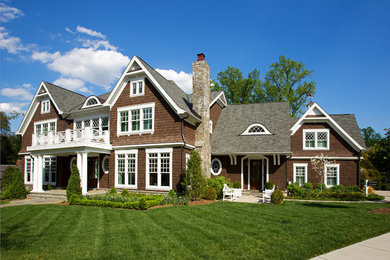 Example of a large beach style brown two-story wood exterior home design in DC Metro with a shingle roof