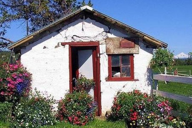 Example of a huge farmhouse red two-story wood exterior home design in Other with a shed roof