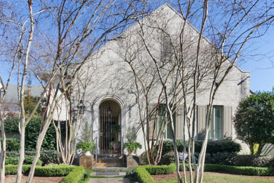 Example of a transitional beige two-story brick exterior home design in New Orleans with a shingle roof