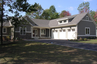 Example of a large arts and crafts green two-story wood gable roof design in Grand Rapids