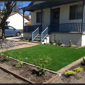 Artificial turf installation and paver stones front yard