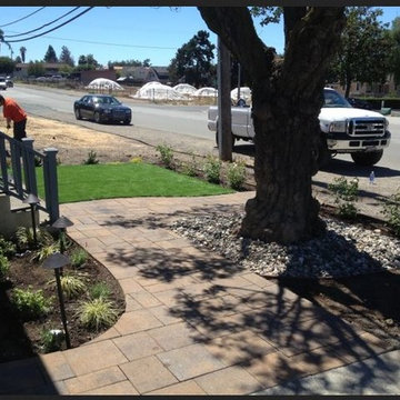 Artificial turf installation and paver stones front yard