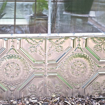 Artistic Greenhouse With Tin Ceiling Tile and Recycled Glass Foundation