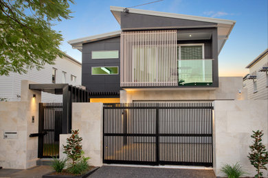 This is an example of a medium sized and gey modern two floor detached house in Brisbane.