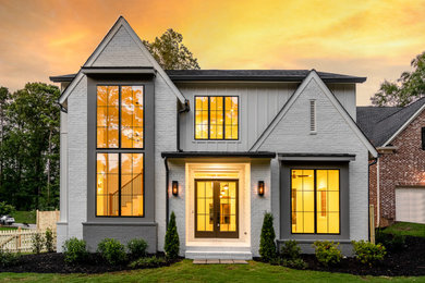 Transitional white two-story brick and board and batten exterior home idea in Atlanta with a shingle roof and a gray roof