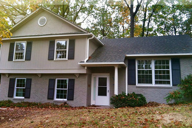 Example of a 1950s gray split-level mixed siding exterior home design in Charlotte