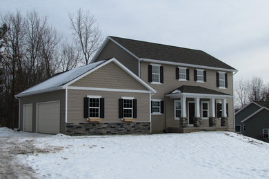 Inspiration for a mid-sized timeless beige two-story vinyl gable roof remodel in Grand Rapids
